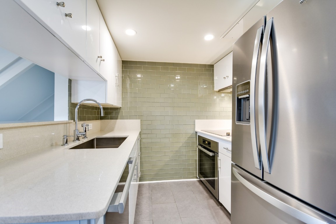 3110 Red River Street, Unit 221 Austin, TX 78705 - Photo 4 of 14 a kitchen with stainless steel appliances granite countertop a refrigerator and a sink
