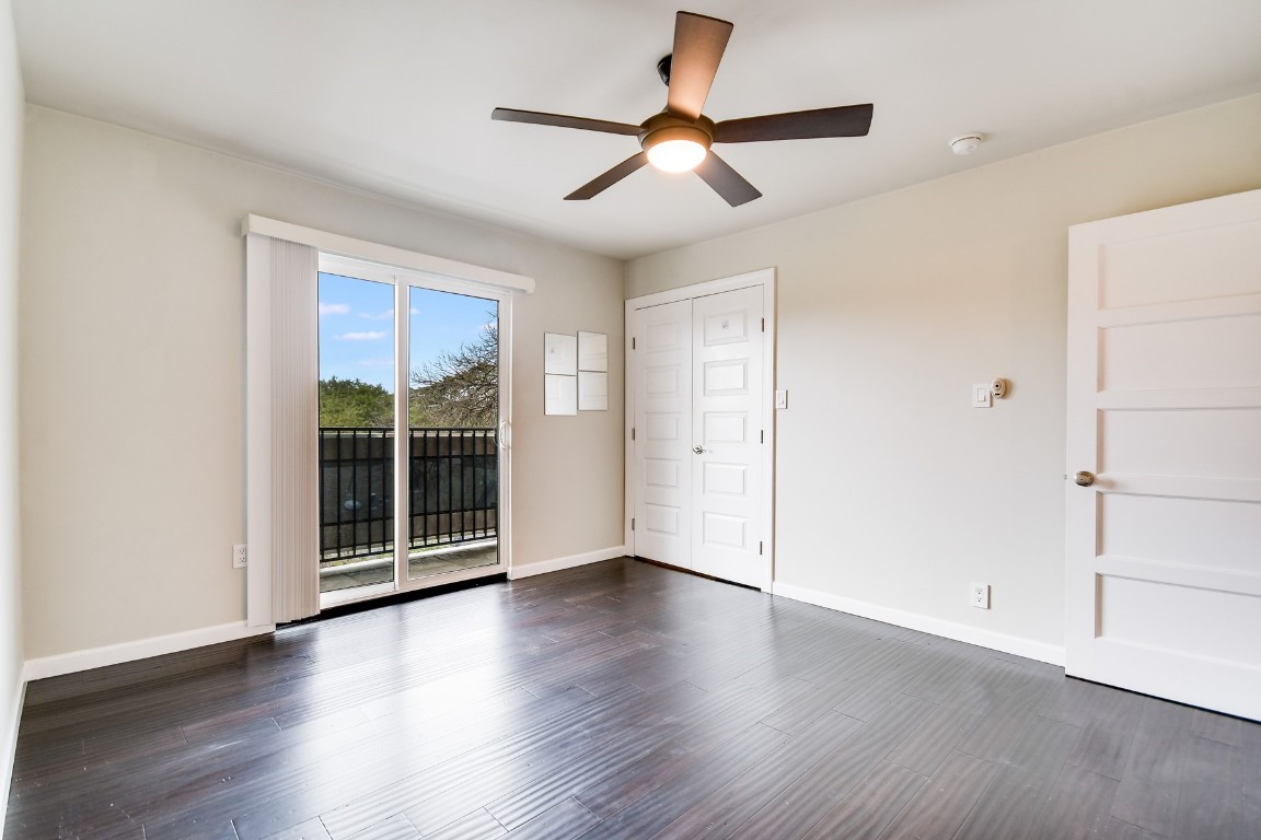 3110 Red River Street, Unit 221 Austin, TX 78705 - Photo 7 of 14 an empty room with wooden floor and windows