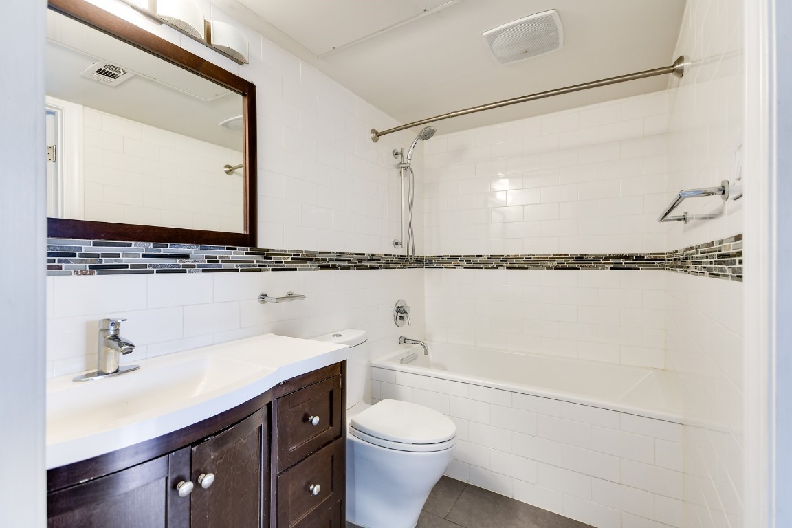 3110 Red River Street, Unit 221 Austin, TX 78705 - Photo 10 of 14 a bathroom with a sink a toilet and a mirror