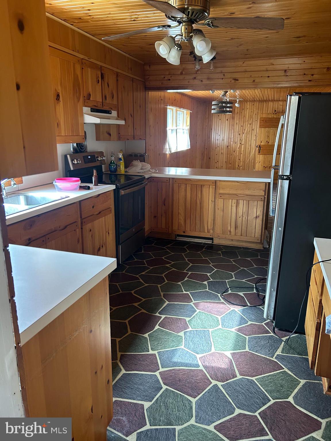 824 Brunnerville Road Lititz, PA 17543 - Photo 5 of 7 a kitchen with stainless steel appliances a sink a stove a microwave a dining table and chair