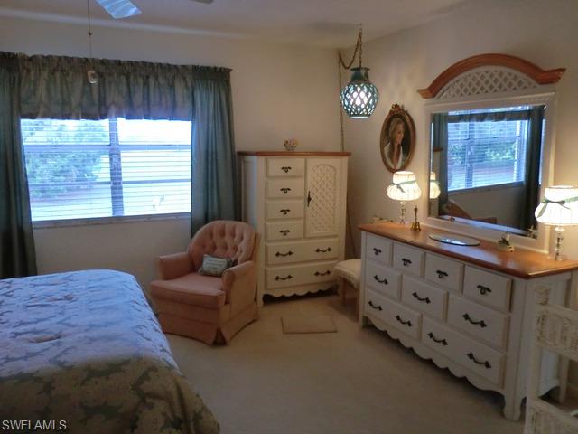 4372 27th Court Southwest, Unit 210 Naples, FL 34116 - Photo 11 of 19 a bedroom with furniture and a window