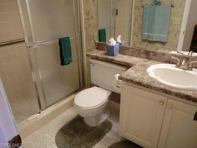 4372 27th Court Southwest, Unit 210 Naples, FL 34116 - Photo 12 of 19 a bathroom with a granite countertop sink toilet and shower