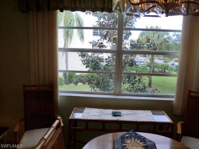 4372 27th Court Southwest, Unit 210 Naples, FL 34116 - Photo 14 of 19 a bedroom with a bed and a window