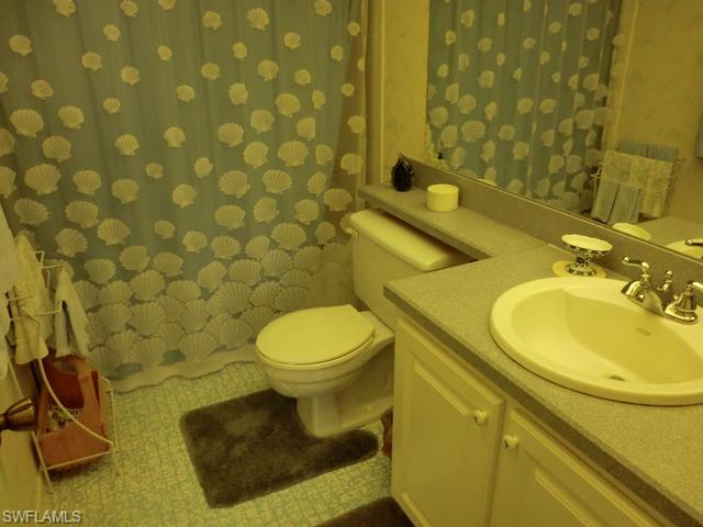 4372 27th Court Southwest, Unit 210 Naples, FL 34116 - Photo 15 of 19 a bathroom with a sink mirror vanity and toilet
