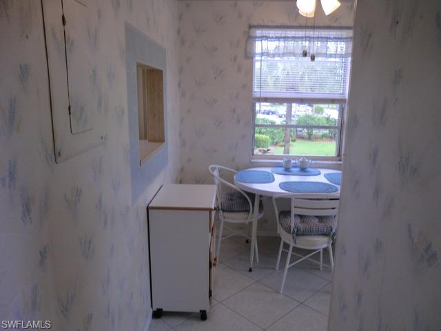 4372 27th Court Southwest, Unit 210 Naples, FL 34116 - Photo 5 of 19 a view of a dining room with furniture window and outside view