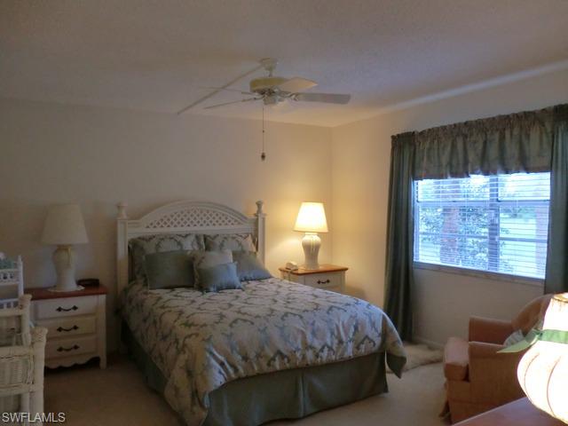 4372 27th Court Southwest, Unit 210 Naples, FL 34116 - Photo 10 of 19 a bedroom with a bed and a window