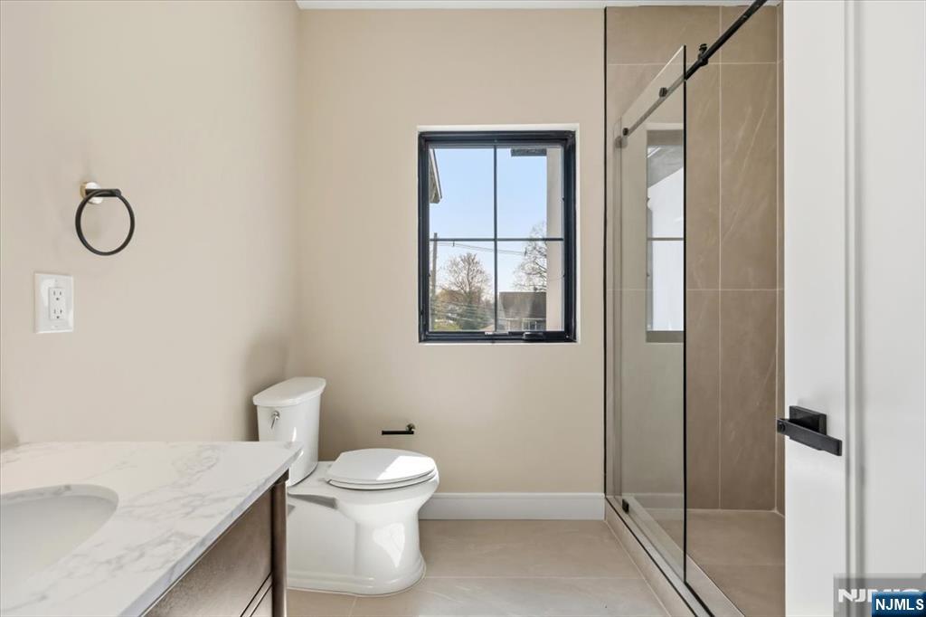 150 Howland Avenue River Edge, NJ 07661 - Photo 32 of 45 a bathroom with a granite countertop toilet and a sink