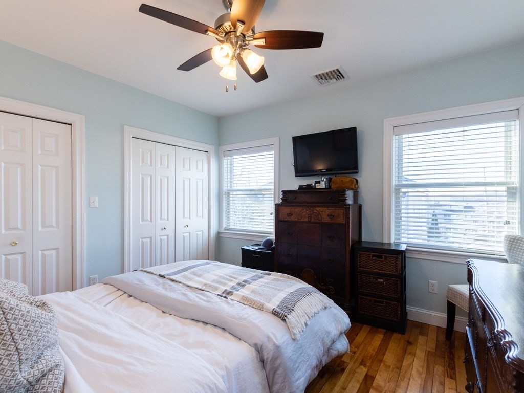 31-33 College Hill Road Somerville, MA 02144 - Photo 12 of 38 a bedroom with a bed and a flat tv screen on dresser