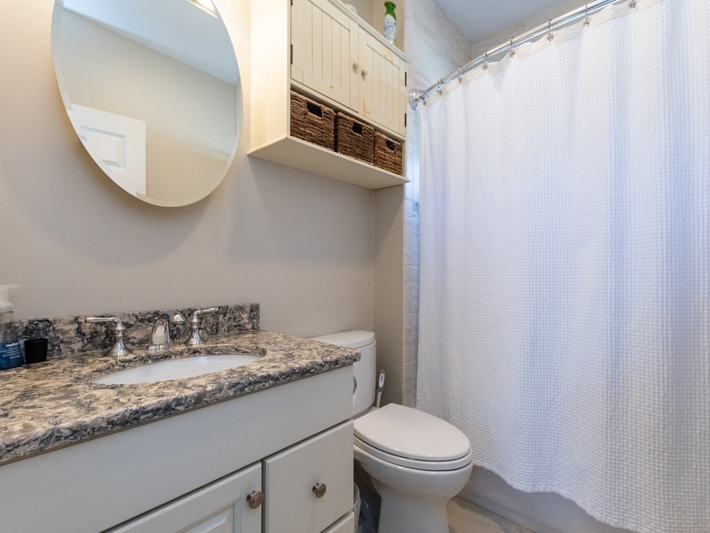 31-33 College Hill Road Somerville, MA 02144 - Photo 14 of 38 a bathroom with a granite countertop sink and a mirror