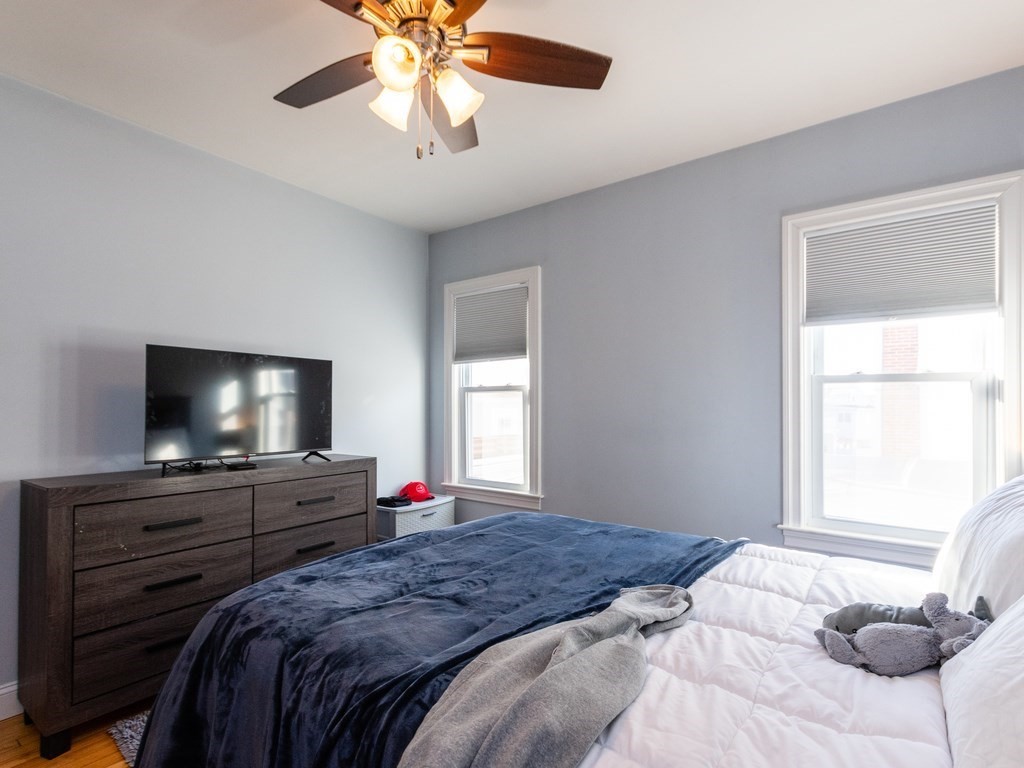 31-33 College Hill Road Somerville, MA 02144 - Photo 26 of 38 a bedroom with a bed and a flat screen tv
