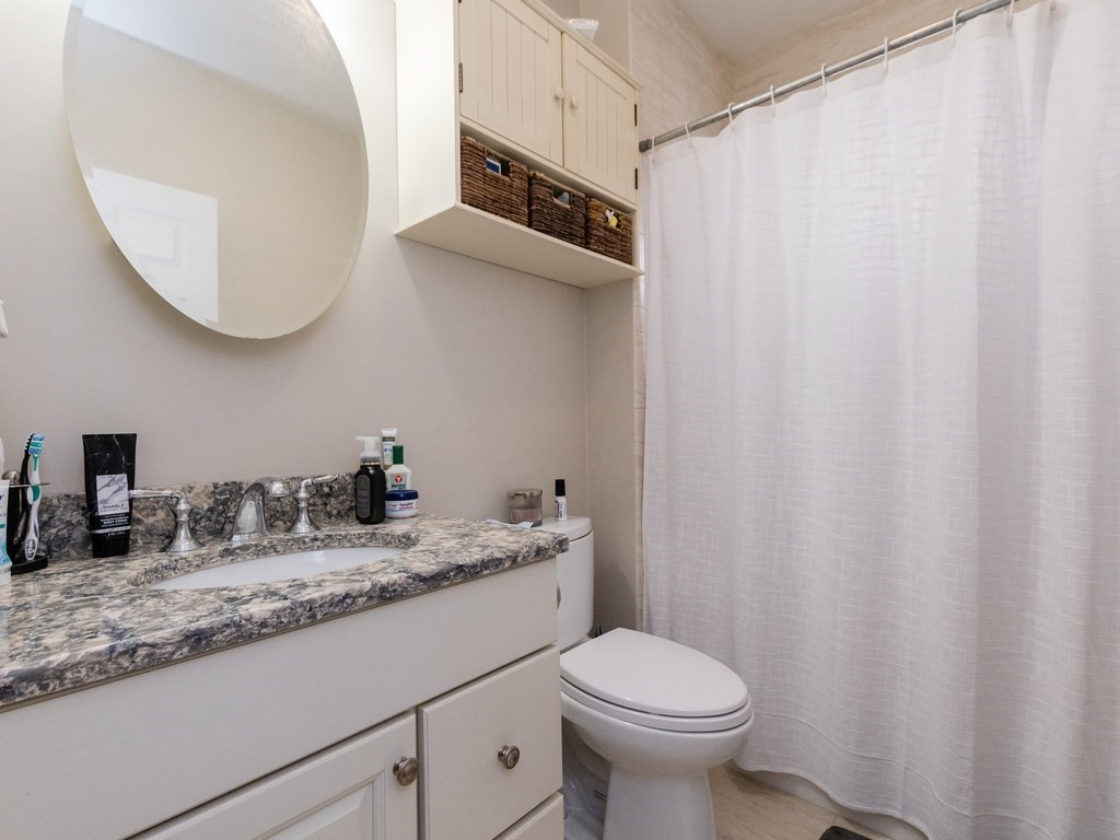 31-33 College Hill Road Somerville, MA 02144 - Photo 30 of 38 a bathroom with a granite countertop sink and a mirror