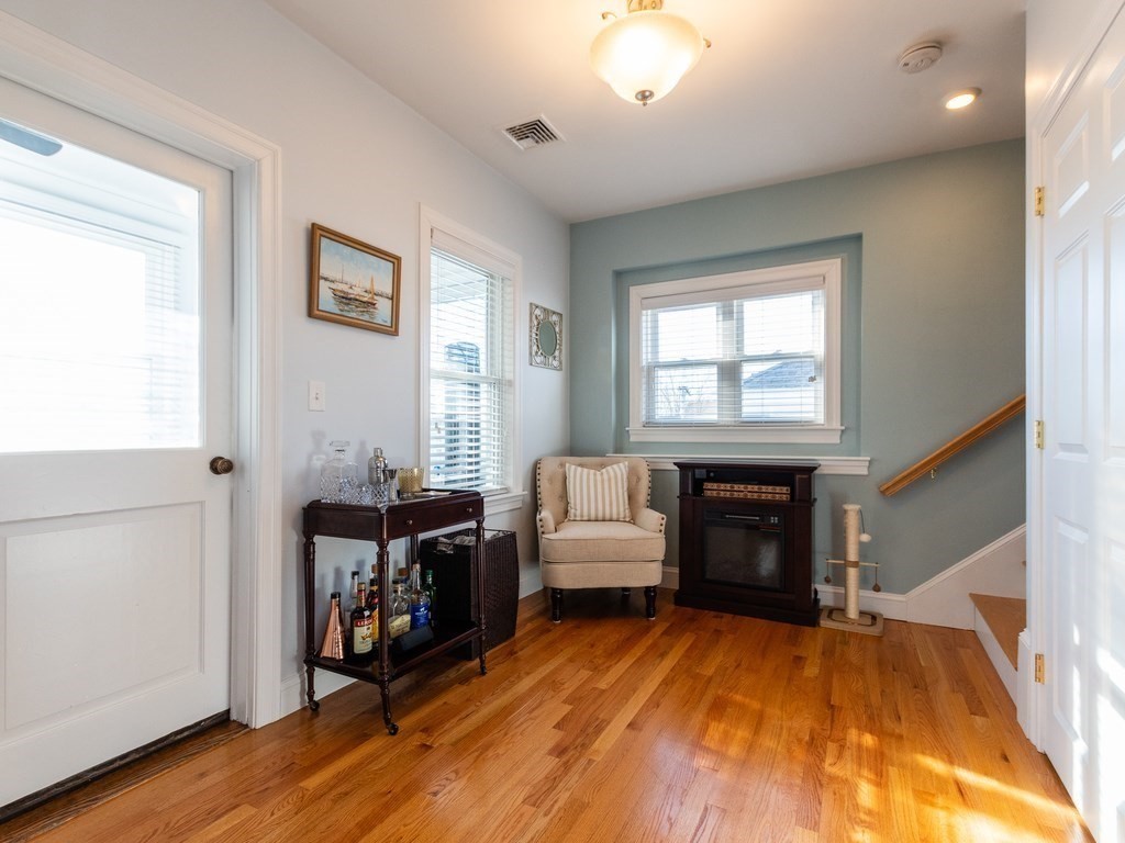 31-33 College Hill Road Somerville, MA 02144 - Photo 7 of 38 a living room with furniture and a fireplace