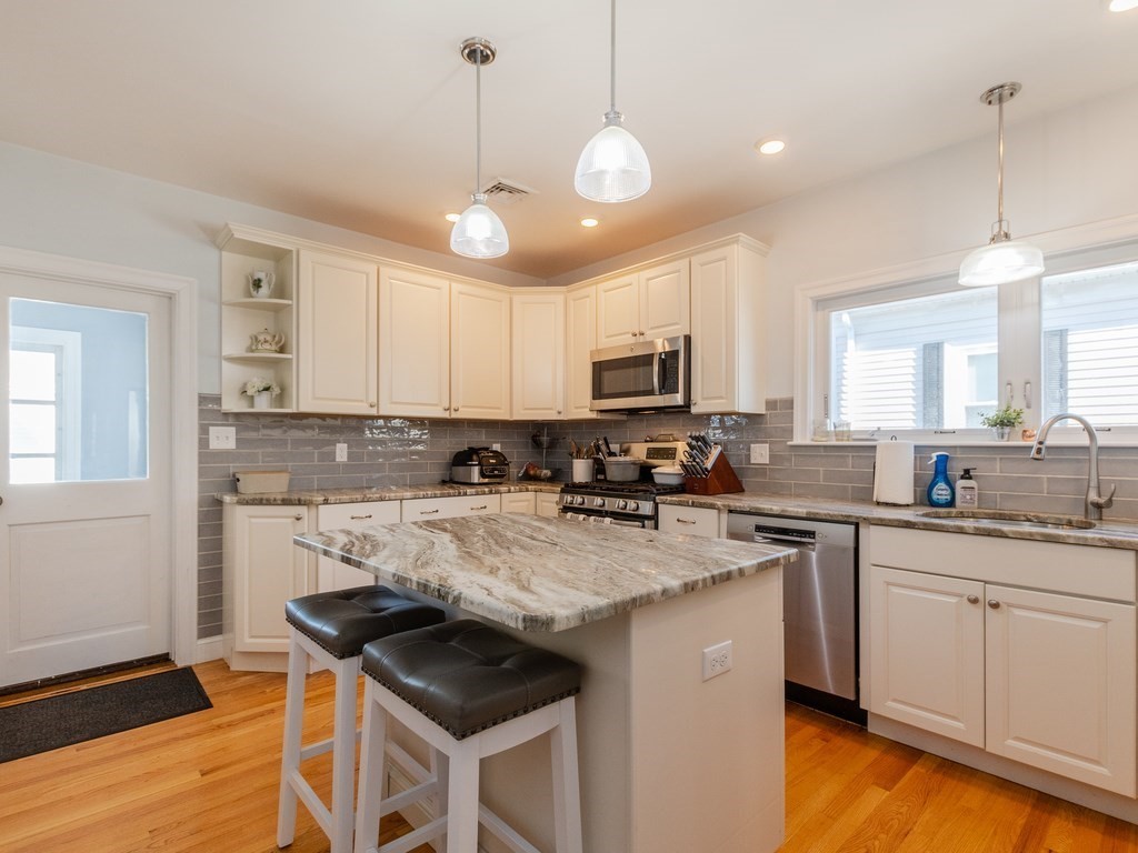 31-33 College Hill Road Somerville, MA 02144 - Photo 9 of 38 a kitchen with a stove cabinets and window