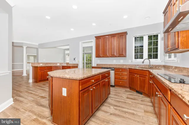 a spacious bathroom with a granite countertop sink and a mirror