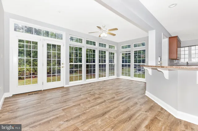 a view of empty room with wooden floor and fireplace