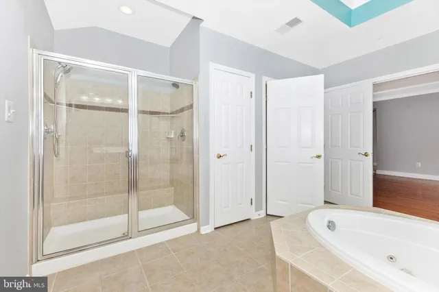 a bathroom with a granite countertop toilet sink and a bathtub