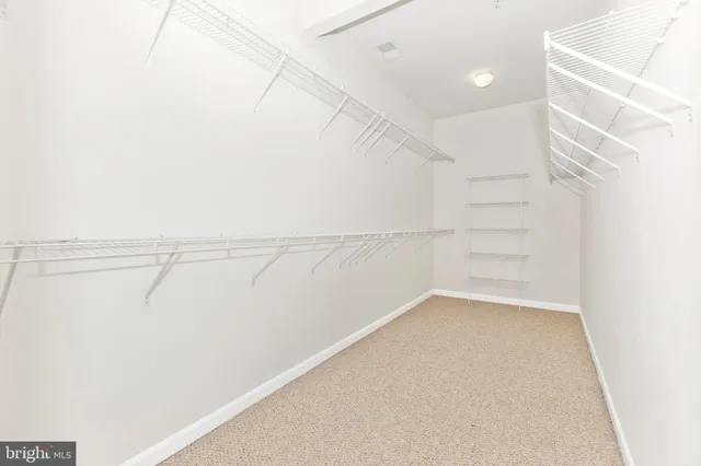 a spacious bathroom with a double vanity sink and mirror