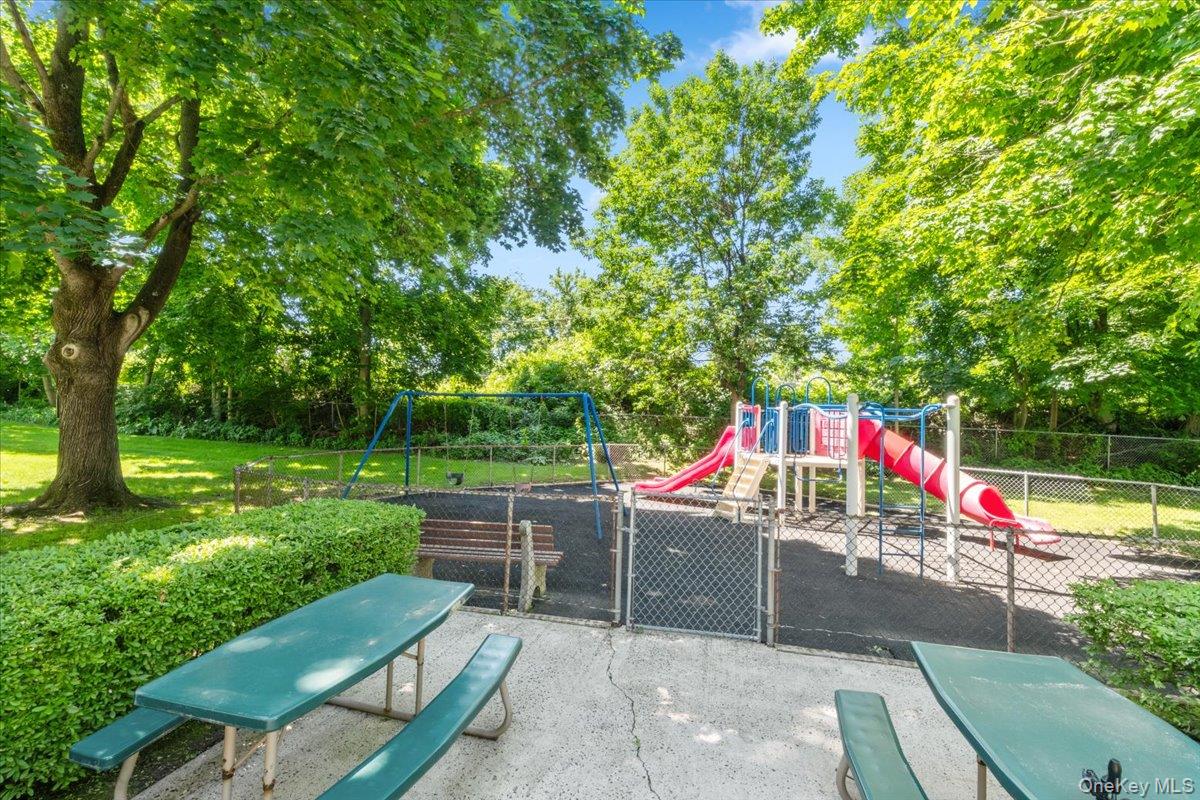 51 Avon Circle, Unit D Rye Brook, NY 10573 - Photo 27 of 30 Rye Ridge Condo Playground and patio area with outdoor table seating area