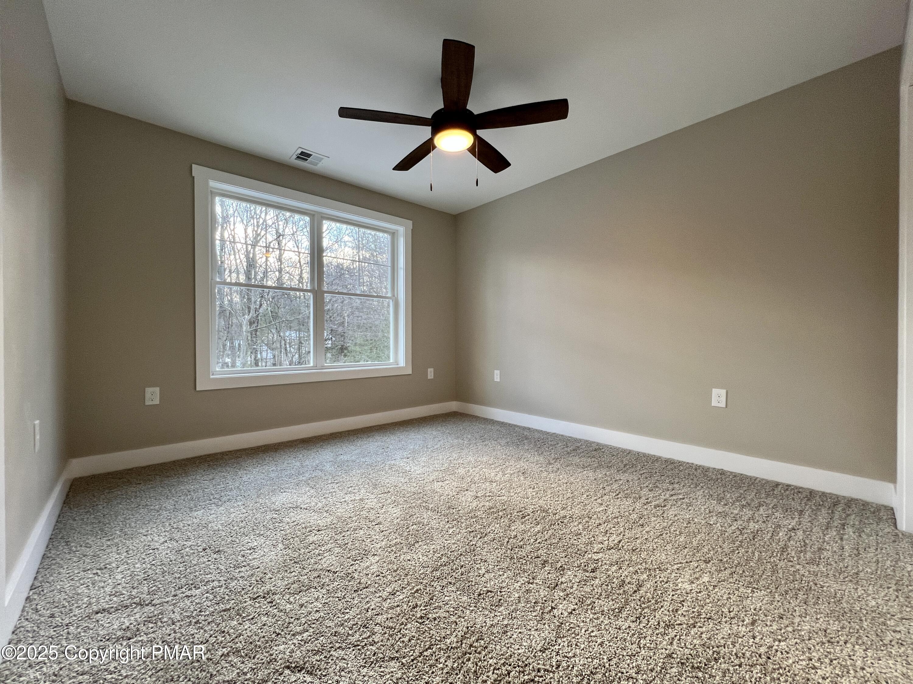 253 Hawthorn Lane Kunkletown, PA 18058 - Photo 30 of 39 an empty room with windows and ceiling fan