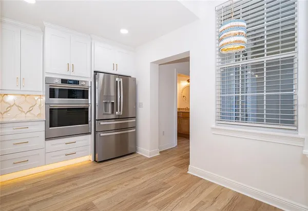 a kitchen with stainless steel appliances a refrigerator and a stove top oven