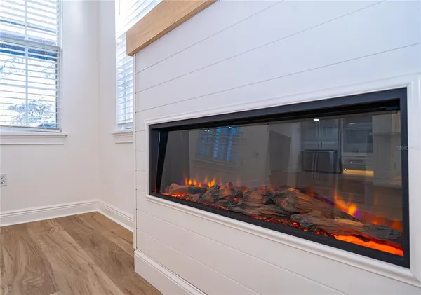 a room with wooden floor and a fireplace