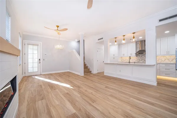 a view of large kitchen with kitchen island sink and refrigerator