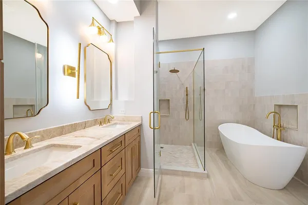 a spacious bathroom with a double vanity sink mirror and double