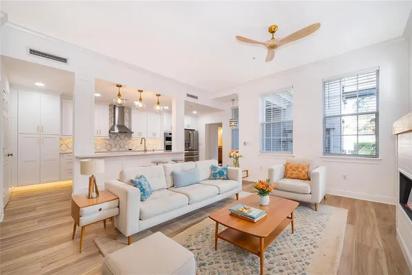 a living room with furniture and a wooden floor