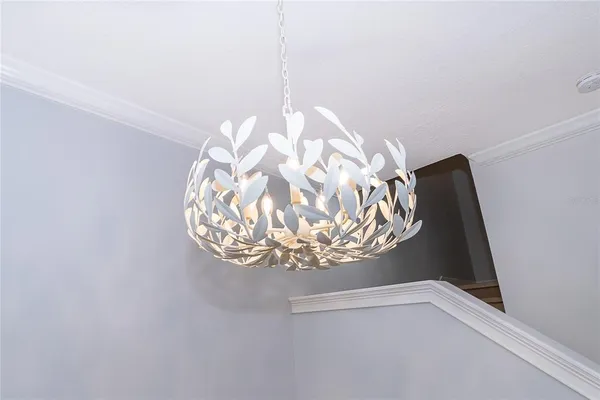 a view of a livingroom with wooden floor and a ceiling fan