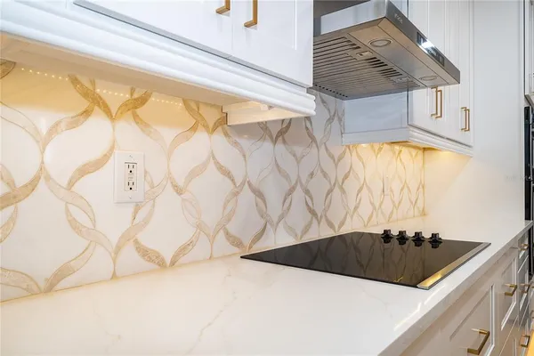 a kitchen with a sink a bed and a window