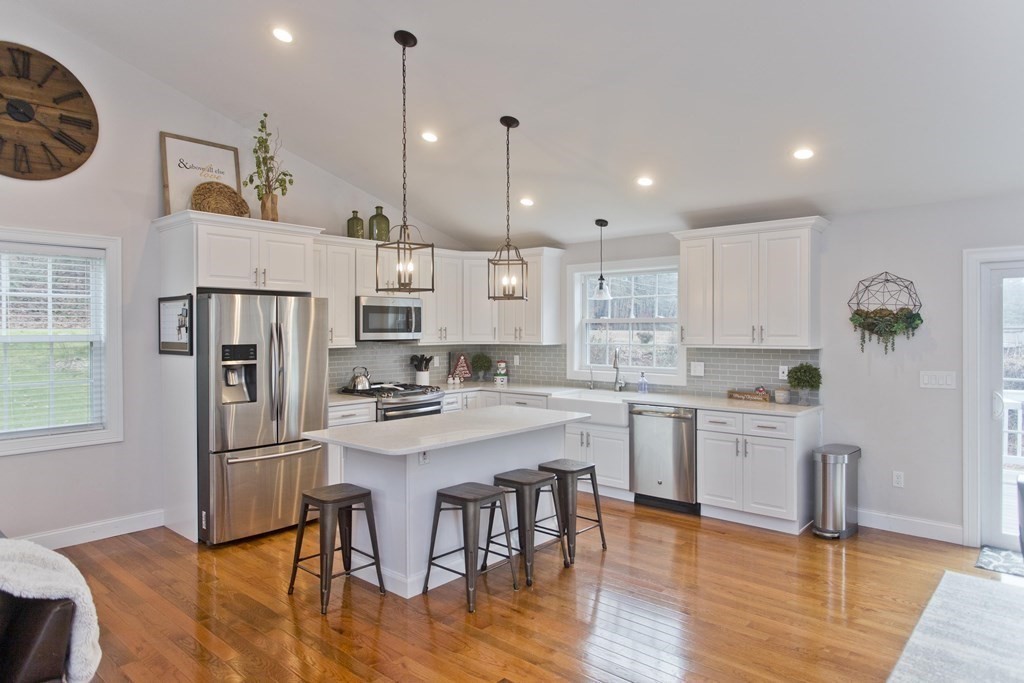 19 Valley Road Southampton, MA 01073 - Photo 10 of 32 a kitchen with stainless steel appliances granite countertop a refrigerator a sink dishwasher a stove and white cabinets with wooden floor