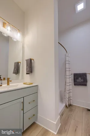 a bathroom with a sink a mirror and shower