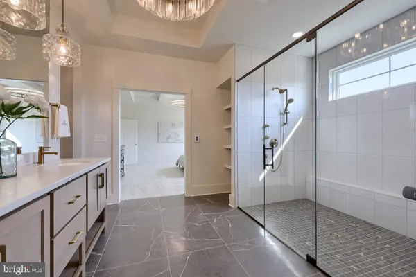 a bathroom with a sink a mirror and a shower