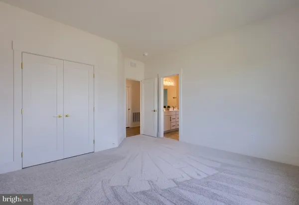 a view of an empty room and wooden floor