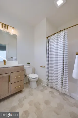 a bathroom with a toilet sink and shower