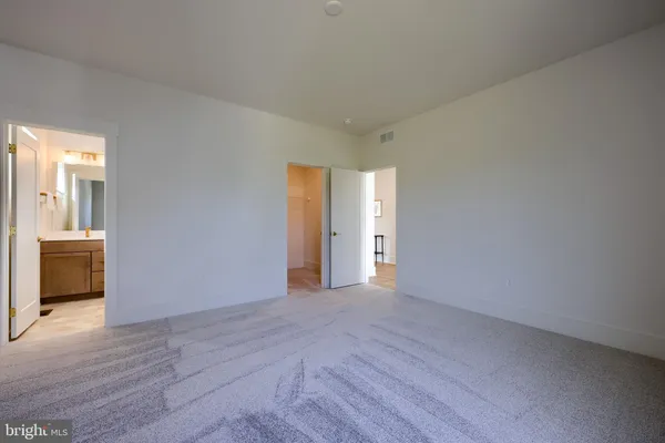 a view of an empty room and glass door