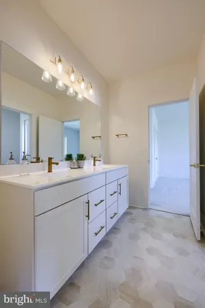 a spacious bathroom with double sink and a mirror