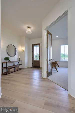a view of a livingroom with furniture and a mirror