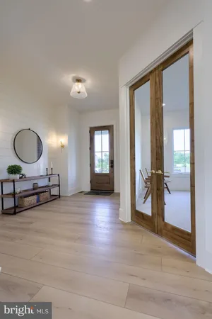 a view of a livingroom with furniture and a mirror