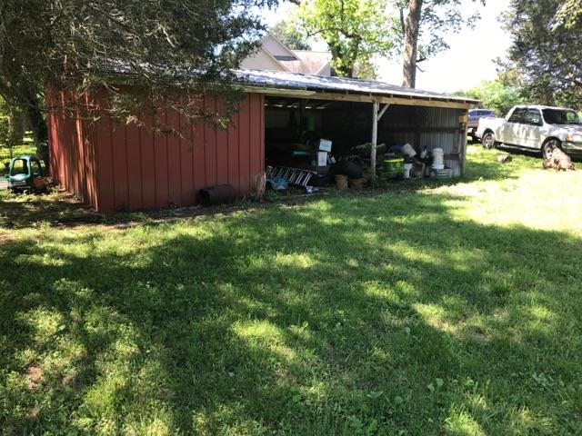 471 Ligon Road Lebanon, TN 37090 - Photo 7 of 18 a view of a backyard with table and chairs and wooden fence