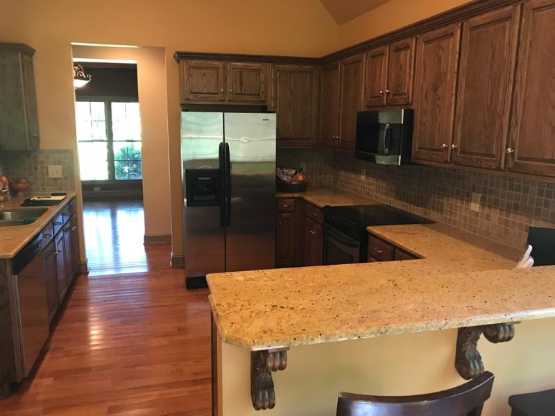 471 Ligon Road Lebanon, TN 37090 - Photo 8 of 18 a kitchen with kitchen island granite countertop wooden cabinets a sink a stove and a refrigerator
