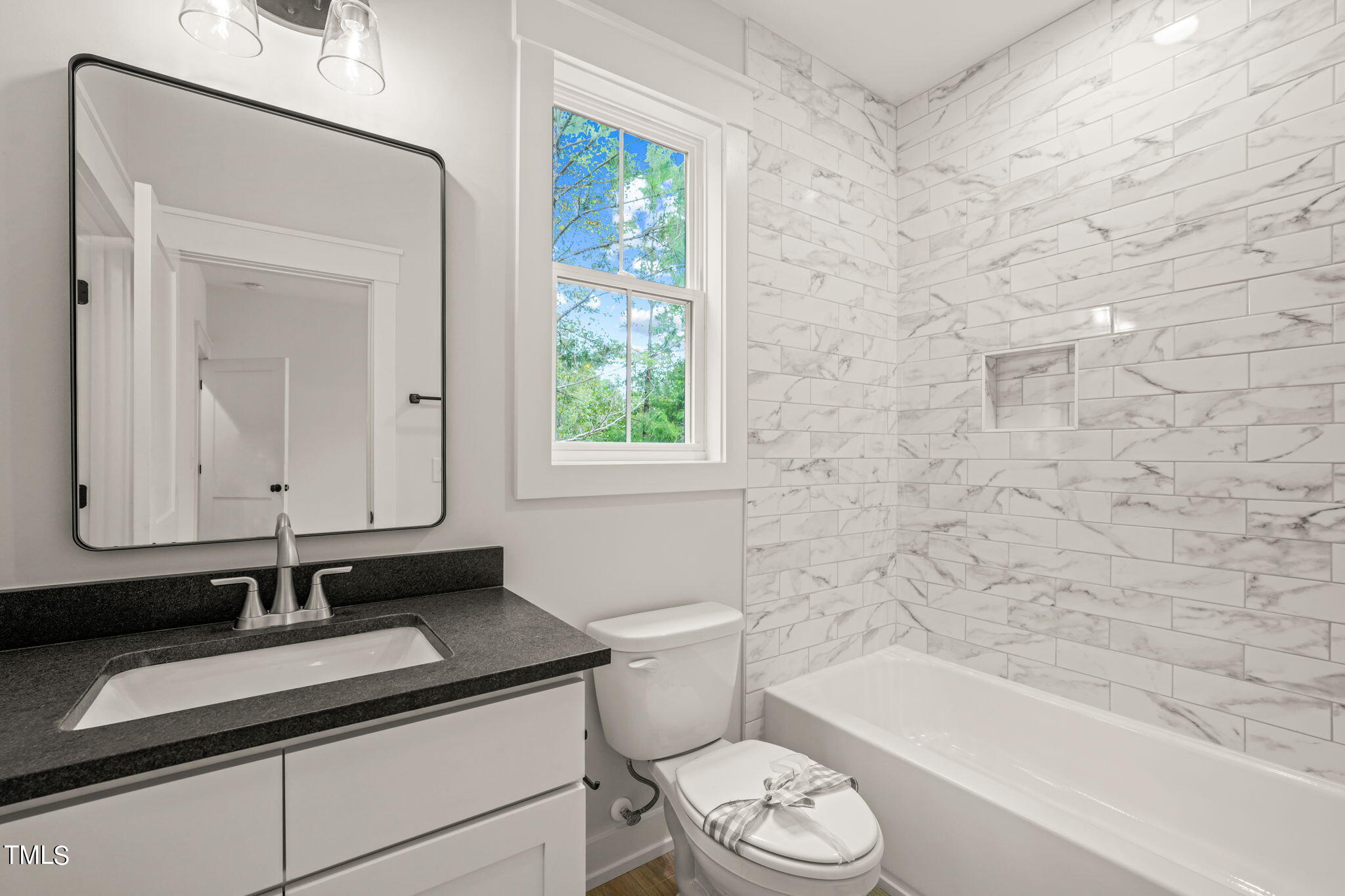 210 Pilot Ridge Road Zebulon, NC 27597 - Photo 29 of 46 a bathroom with a granite countertop sink a toilet and bathtub
