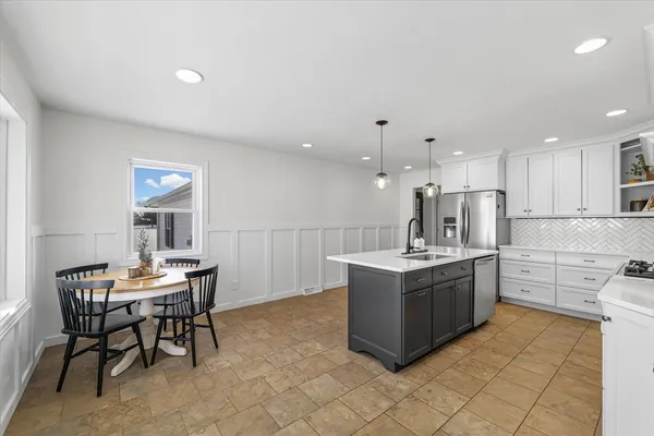 a kitchen with granite countertop a sink stove and cabinets