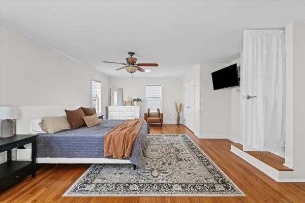 a bedroom with a large bed and a flat screen tv
