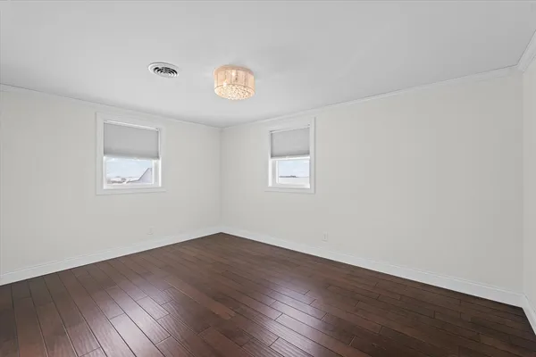 a view of a room with wooden floor and window