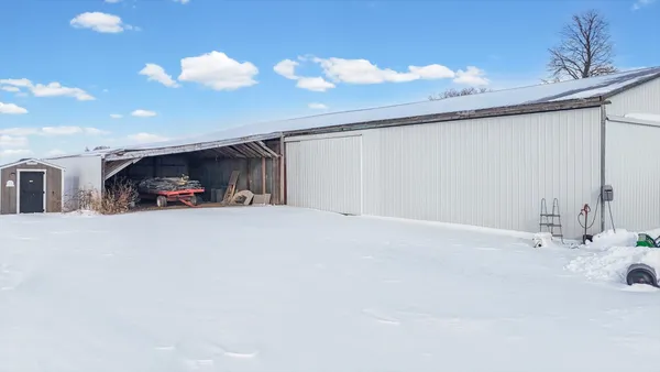 a picture of a room with a white wall and refrigerator