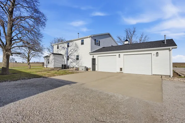a view of large house with a big yard and large tree