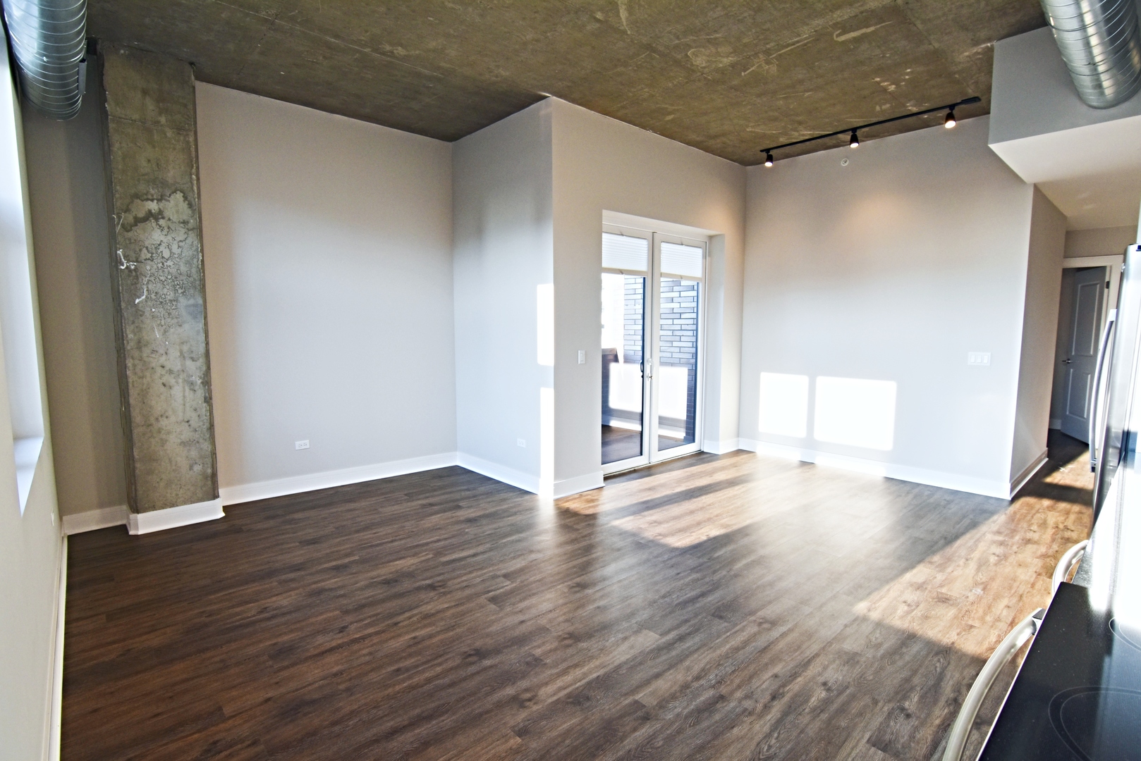 Undisclosed Address Chicago, IL 60613 - Photo 3 of 11 an empty room with wooden floor and windows