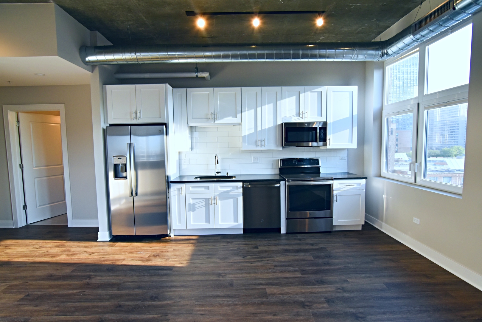 Undisclosed Address Chicago, IL 60613 - Photo 5 of 11 a kitchen with granite countertop a refrigerator and a stove