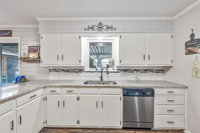 a kitchen with granite countertop white cabinets and white appliances